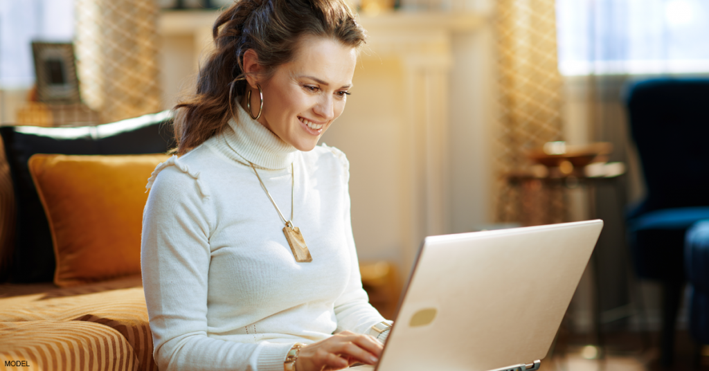 Woman wears a turtleneck sweater to cover her neck during a Zoom meeting.